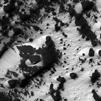 Cassini close-up showing bright terrain coated with dark material
