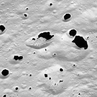 Cassini image with dark material splattered on light trerrain