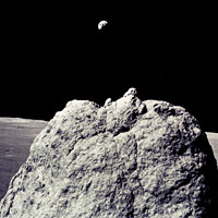 Large boulder on the Moon with the Earth in the background