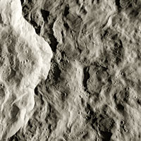 Cassini close-up image revealing ridges on the rim of a crater 