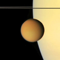 Cassini image of Titan in orbit above the planet Saturn