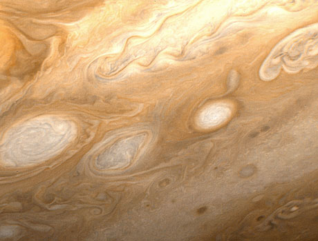 Close-up image of Jupiter taken by the Voyager 1 spacecraft showinf shite spots in the atmosphere