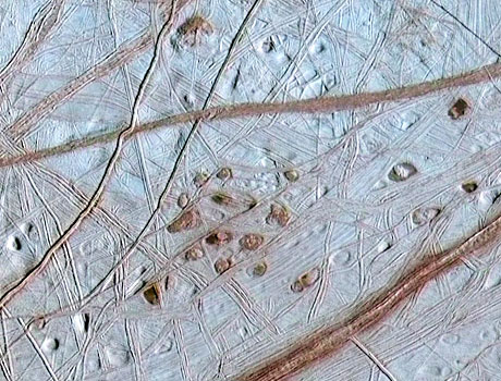 Image of Jupiter's moon Europa taken by NASA's Galileo spacecraftshowing several brown spots on the icy surface
