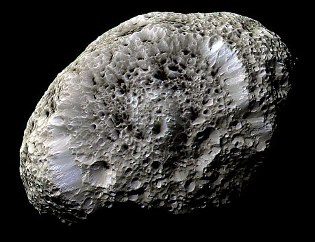 Color close-up view of Saturn's tiny moon Hyperion captured by NASA's Cassini spacecraft, showing its heavily cratered surface