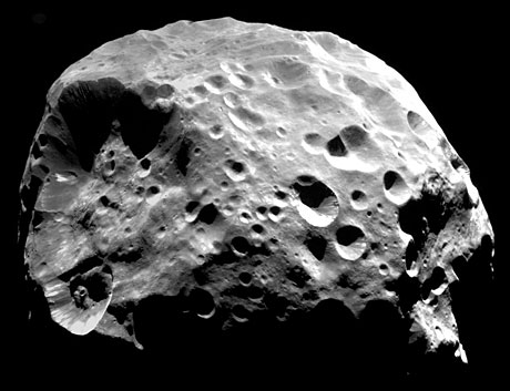 Color close-up view of Saturn's tiny moon Hyperion captured by NASA's Cassini spacecraft, showing its heavily cratered surface